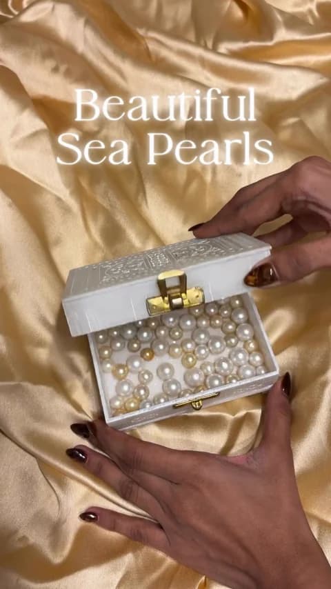 Loose sea pearls in different sizes and colours, displayed in a decorative box.