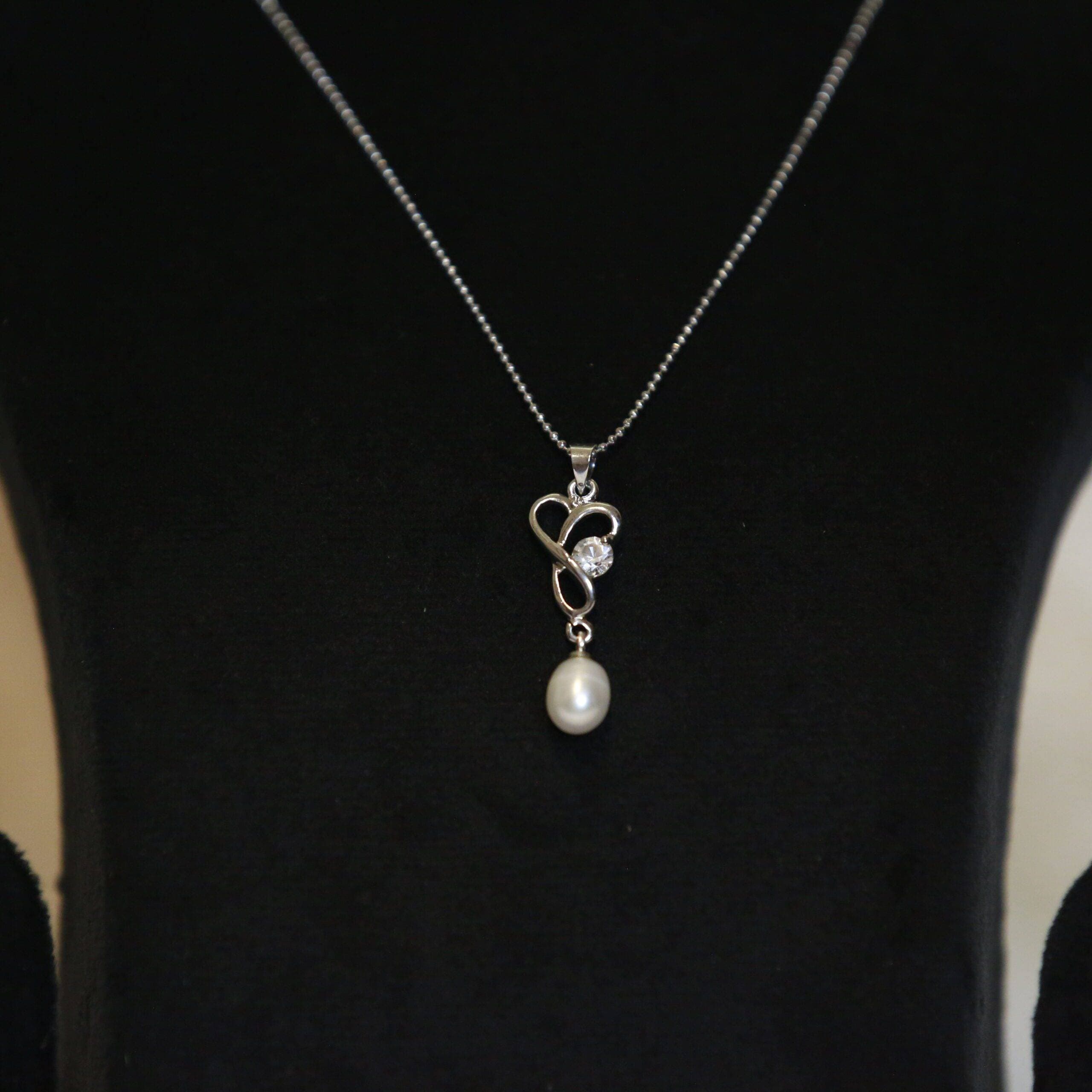 Twirled Knot Pendant Accentuated With 7mm Oval White Pearl & CZ