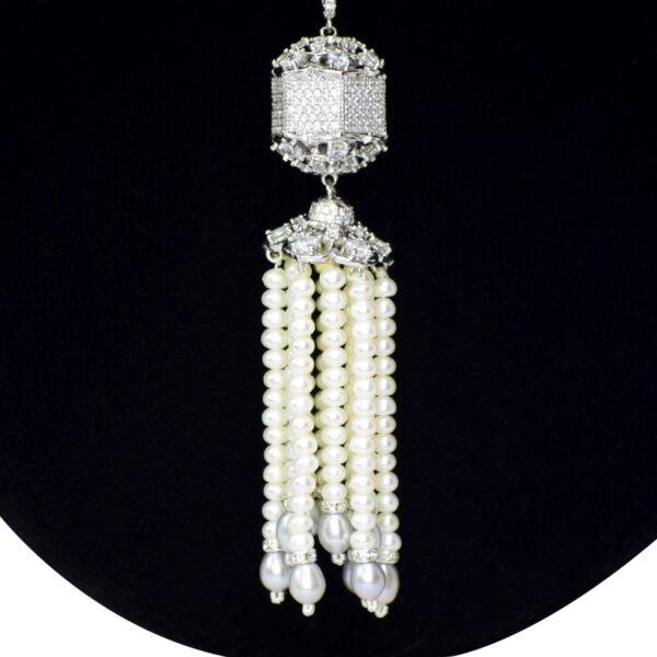 White pearls necklace featuring a very cute silver droplet studded with zircons and pearl hangings close up